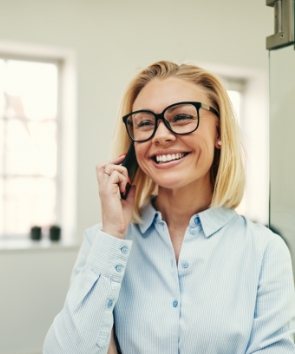 businesswoman-smiling-and-talking-on-her-4C3HEDM